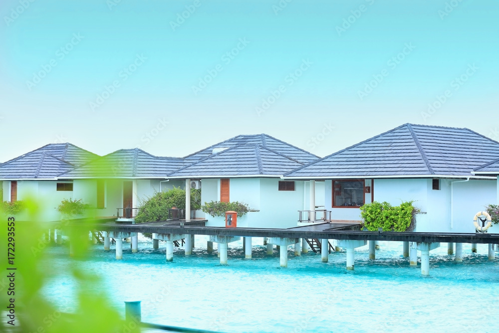 Sticker View of modern beach houses on piles at tropical resort