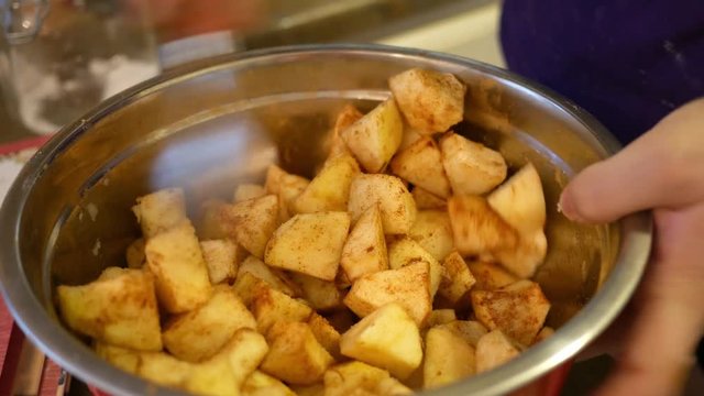 Chopped up apples with cinnamon in food bowl for apple dumplings