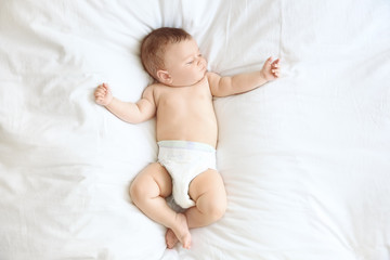 Cute little baby sleeping on bed at home