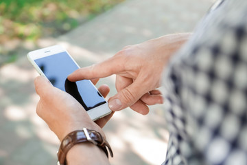 Man using smartphone outdoors