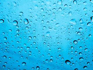 Rain water Drops On blue Background.