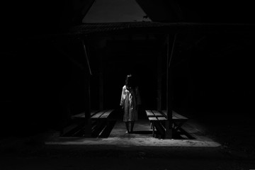 Mysterious Woman, Horror scene of scary ghost woman standing outdoor on Thai style old pavillion with light in white tone