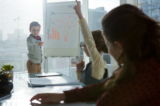 Kids As Business Executives Interacting While Meeting