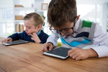 Boy as business executive using digital tablet