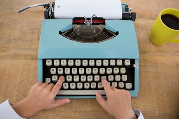 Hand of boy as business executive using typewriter