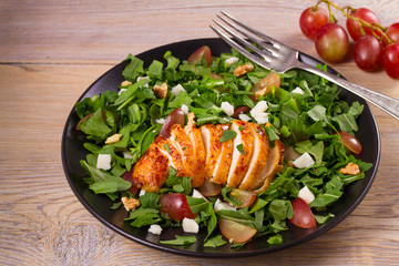 Chicken, grape, arugula, cheese and walnuts salad, horizontal