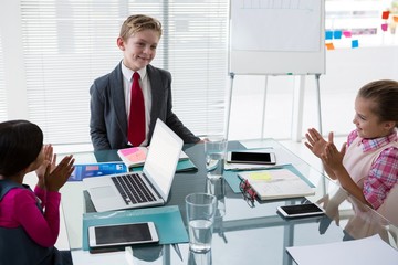 Kids as business executives interacting while meeting