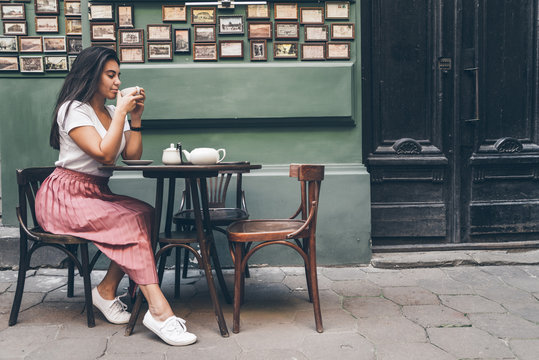 Woman In A Street Cafe Dreanking Tea