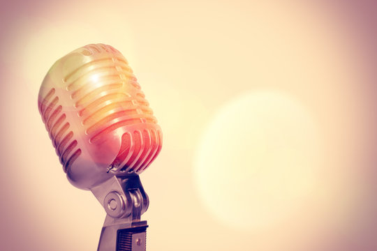 Stage microphone on a glowing abstract background. Toned