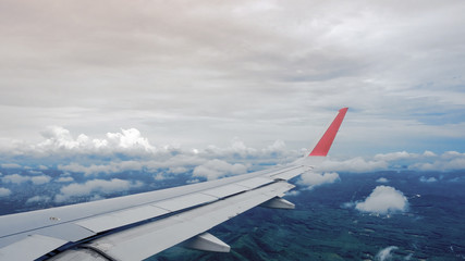 Aerial view from aircraft with wing and deep blue sky on landscape