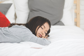 Portrait of asian cute girl sleeping on therbed at home .