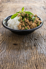 stir fried minced pork with basil with jasmine rice in bowl. thai popular street food