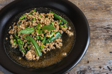 stir fried minced pork with basil in black dish. thai popular street food