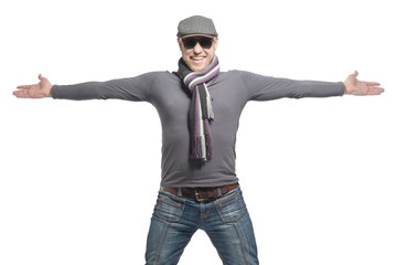 Unshaven bald man wearing a cap, jeans, sunglasses and a scarf is wide open arms. Isolated