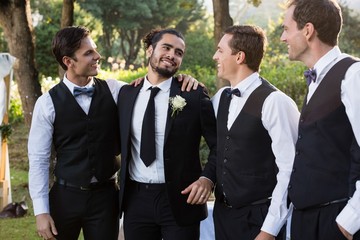 Groom and groomsmen having fun in park