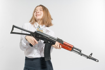 Girl smiling with Kalashnikov in hand. Isolated