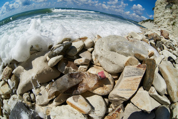 Pollution of environment on stony beach