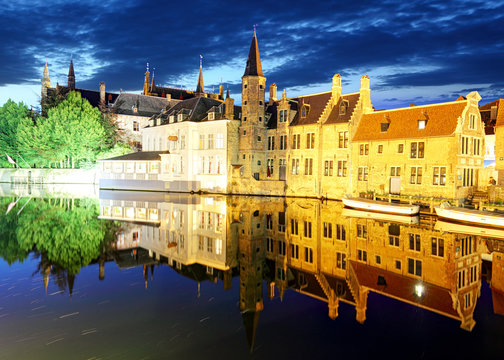 Bruges - Night  historic medieval buildings along a canal, Belgium