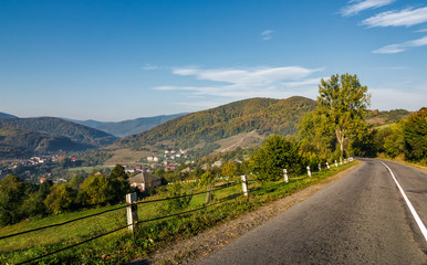 asphalt road in mountainous countryside. beautiful early autumn morning scenery