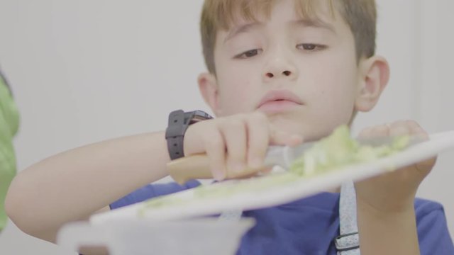 kid cutting avocato