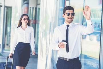 The happy businessman in sunglasses gesture near the woman
