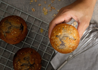 Hands holding a muffin look delicious.
