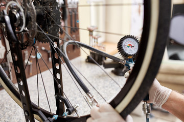 Mechanic repairing a mountain bike in a workshop