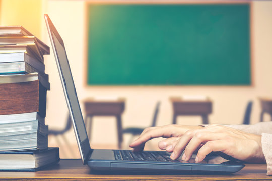 male student hands making research on laptop and browse internet for preparing exam and learning lessons in classroom