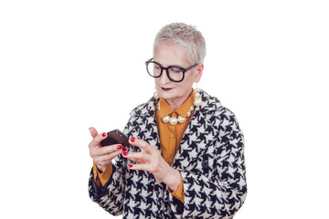 Fototapeta premium Stylish old woman in glasses using smartphone isoladed on white .