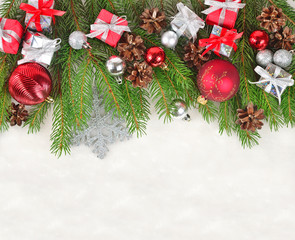 Fototapeta na wymiar Christmas decorations on a spruce branch on a white