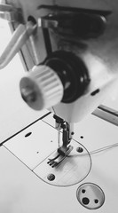 closeup sewing machine head parts needle holder. black and white tone,retro style.