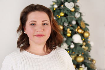 young woman near a Christmas tree