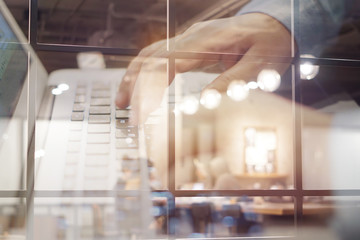 Blurred and soft focus hands typing or recording data of meeting in meeting room, double exposure concept