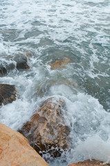 Sea surf during a storm, cloudy weather, gray ocean