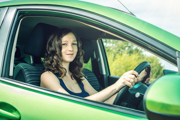 Woman in the car. Hands on the wheel. Focused and tense. Lesson in driving school.