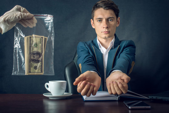 Man Businessman in suit arrested for taking bribe. Caught red-handed. Concept of corruption and bribery