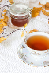 Healthy tea cup, jar of honey on white background. Retro styled.