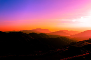 Tourists watch the sunrise on a beautiful morning.