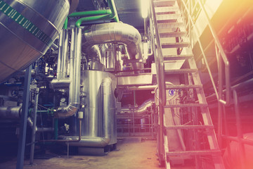 Equipment, cables and piping as found inside of a modern industrial power plant