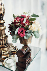Little wooden chest and bronze vase with roses