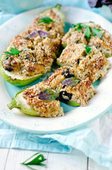Baked zucchini stuffed with cheese and black olives
