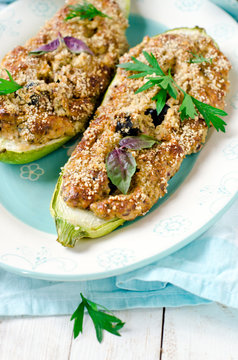 Baked zucchini stuffed with cheese and black olives