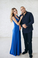 Couple expectant a baby in the white brick wall room