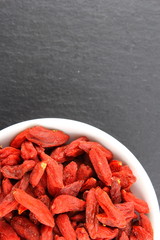 dried goji berries in a small white bowl