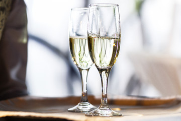 Champagne flutes stand on a tray