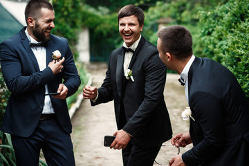 Groom and groomsmen look funny standing in the garden