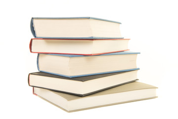 Staple of five books seen from the front isolated on a white background