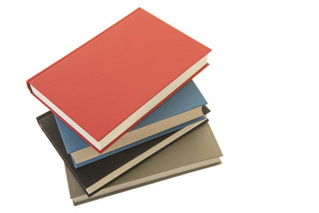 Staple of four books seen from an high angle view isolated on a white background