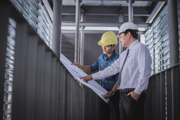 architect and engineer inspect housing estate building to success construction plan before send...