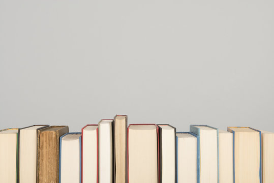 Row of books on a gray background with space for copy